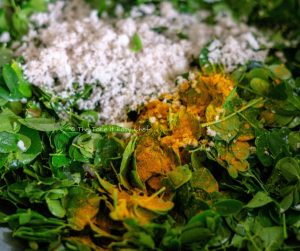 Moringa Leaves Stir-Fry Steps Image - Mixing with grated coconut and turmeric powder