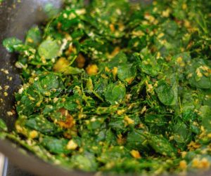 Moringa Leaves Stir-Fry Steps Image - Moringa leaves added to the pan and mixed well