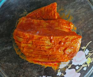 Marinating fish fillets for the pan-fried masala sea bass