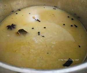 Rice is fried with the spices, boiling water is added