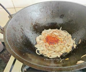Crushed dry chillies added to the pan