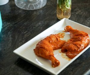 Chicken pieces are scored and coated with the marinade