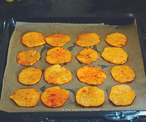 Seasoned sweet potato slices ready to bake