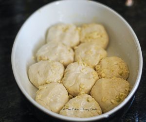 Arrange the coated balls in the baking dish for the Pull Apart Cheesy Garlic Bread