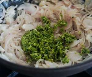 Add the green chilli paste to onions