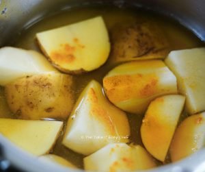 Cook the potatoes with some turmeric powder