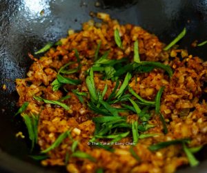 Curry leaves (sliced) added to the onion and chilli flake mix