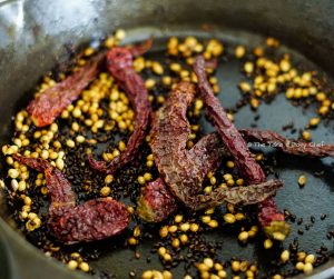 Chilli Bajji Pav Steps - Coriander seeds and Kashmiri chilli added to the frying pan