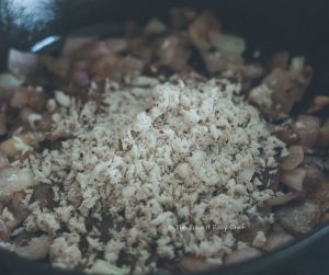 Mushroom Masala Steps - Add grated coconut to fried onions